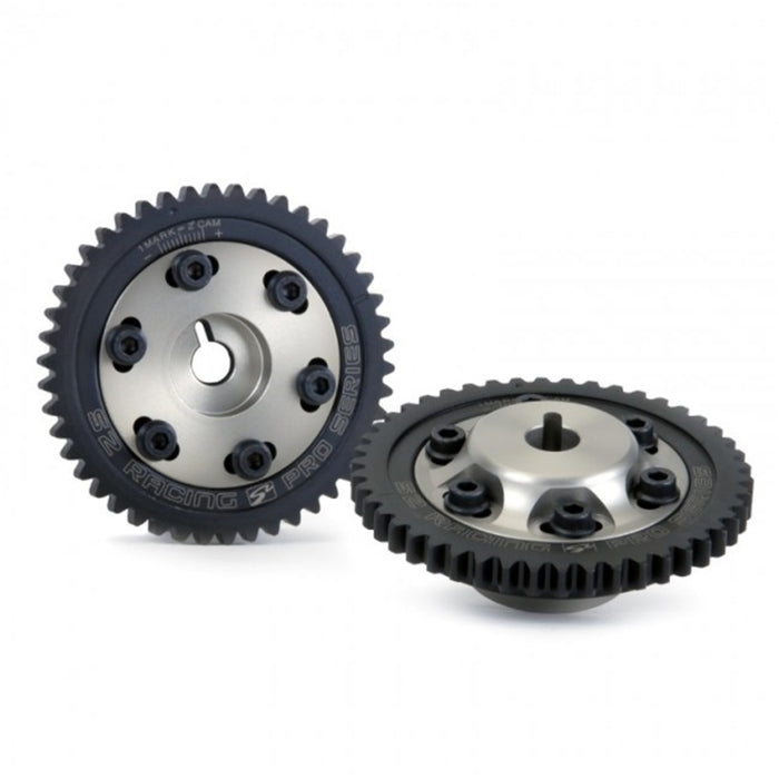 A pair of Skunk2 K Series Pro Series Cam Gears, one with a visible laser-etched timing mark and the other showing a six-bolt design, both in black.